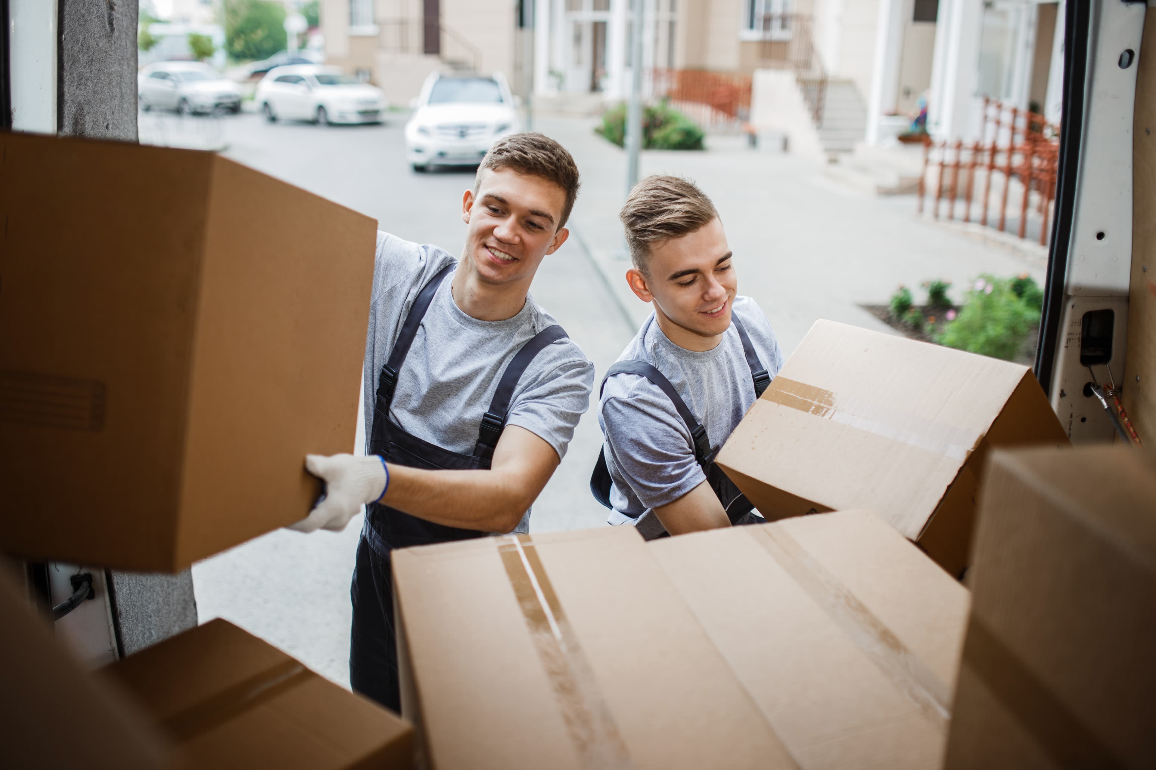 Professional moving crew loading boxes into a moving truck